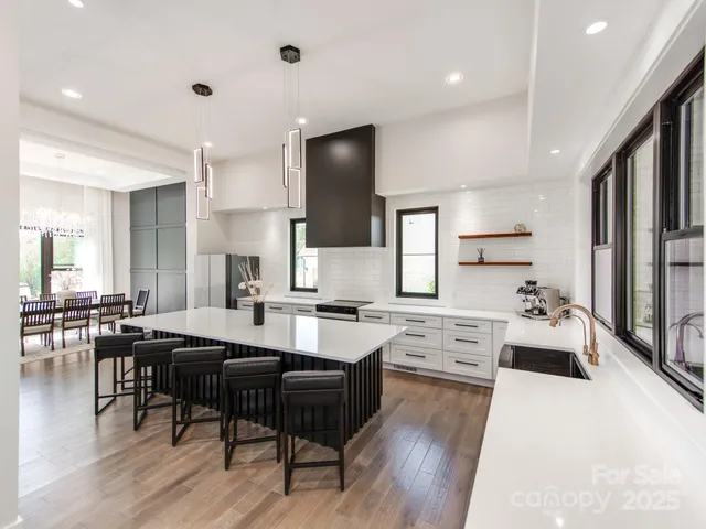 a large kitchen with cabinets table and chairs