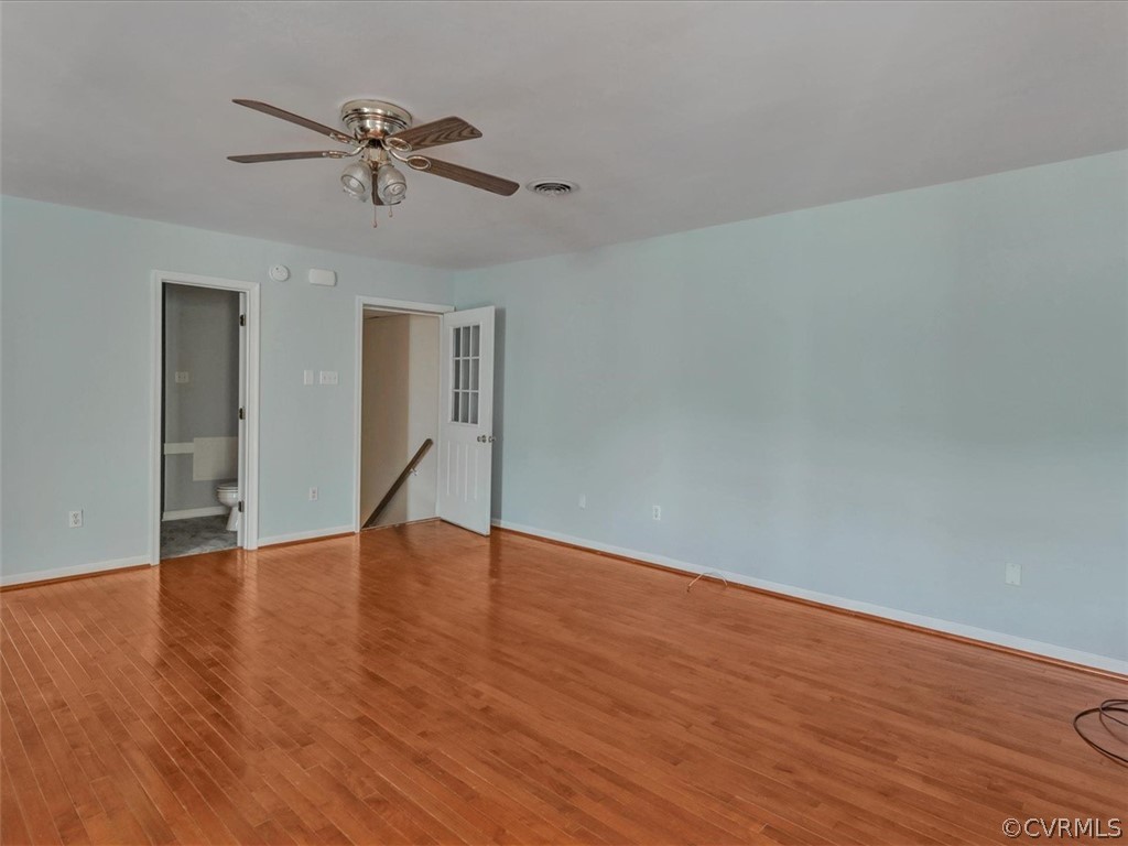 9201 Cattail Road Chesterfield, VA 23838 - Photo 11 of 35 a view of an empty room with wooden floor and a ceiling fan