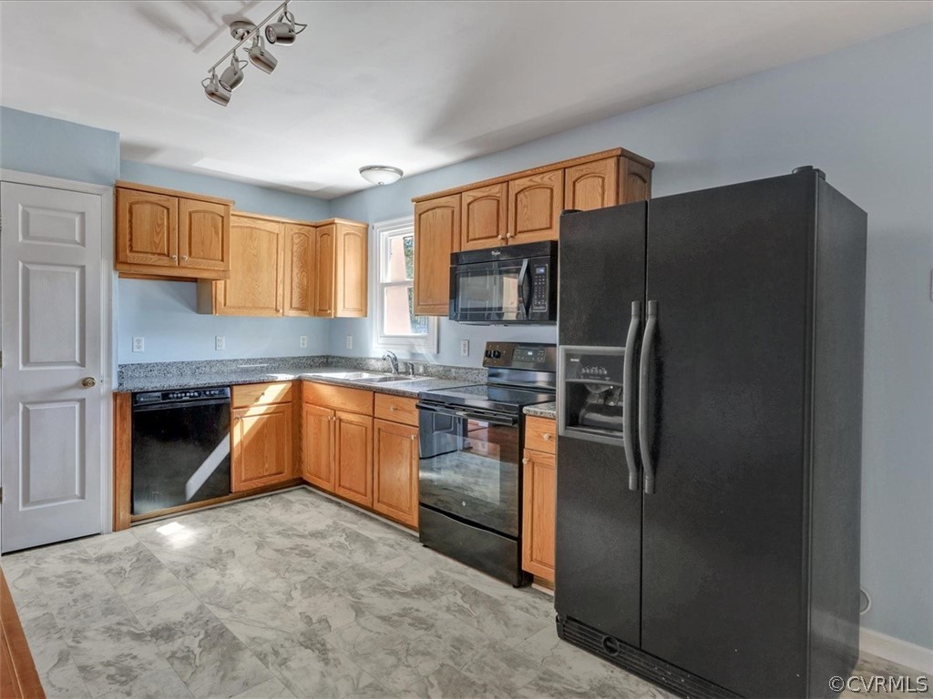 9201 Cattail Road Chesterfield, VA 23838 - Photo 8 of 35 a kitchen with stainless steel appliances granite countertop a refrigerator a stove and a sink with wooden floor