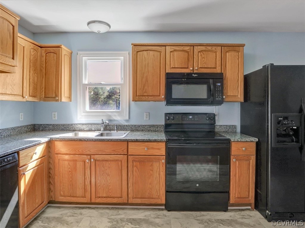 9201 Cattail Road Chesterfield, VA 23838 - Photo 9 of 35 a kitchen with granite countertop a stove top oven microwave and refrigerator