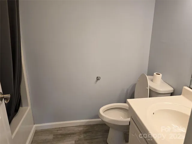 a white toilet sitting next to a bathroom sink