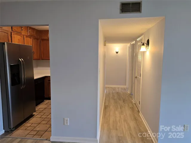 a view of a hallway with wooden floor