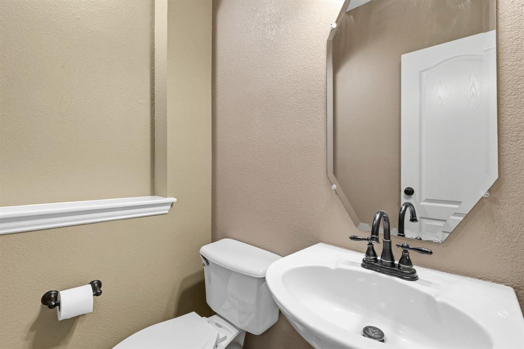 7517 Rodeo Drive Denton, TX 76208 - Photo 33 of 39 Half bath in downstairs front hallway for guests.