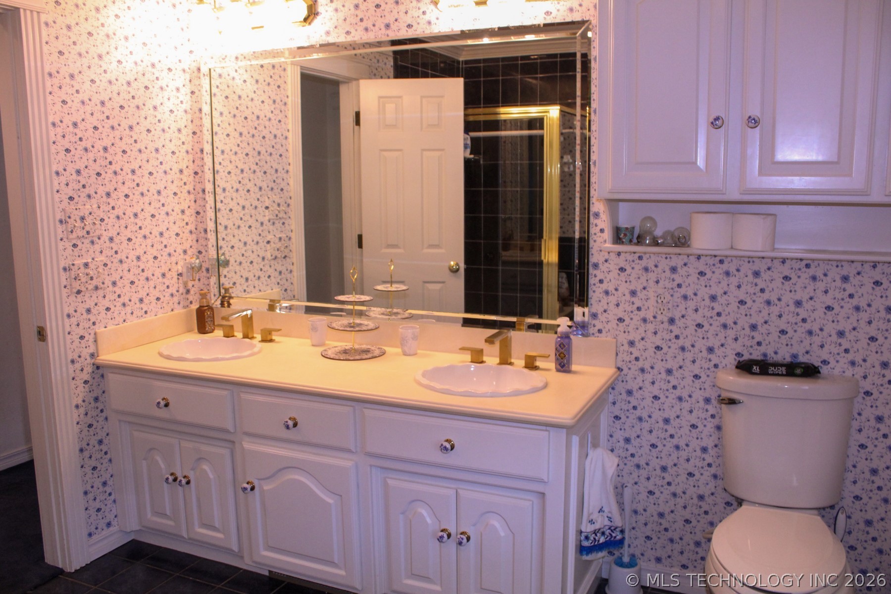 13248 North 3540th Road Maud, OK 74854 - Photo 62 of 98 Double vanity with integrated sinks, white cabinetry, and gold-tone fixtures