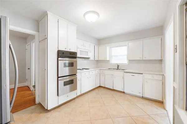 a kitchen with granite countertop cabinets and steel stainless steel appliances