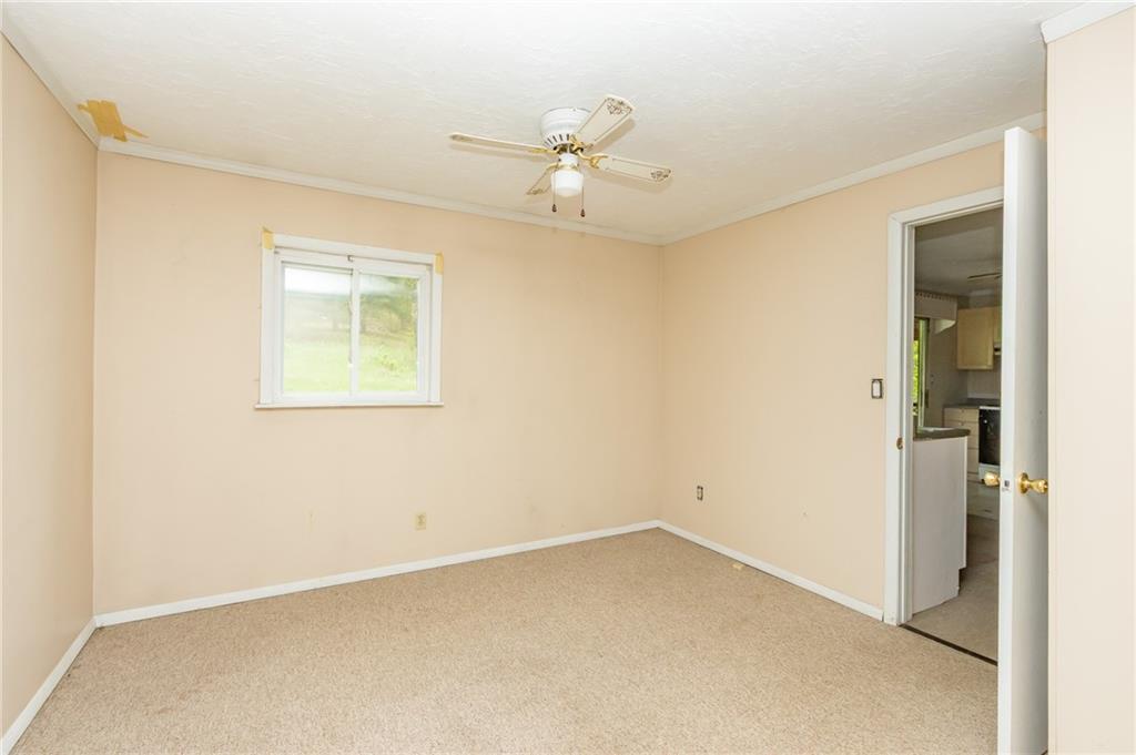 1736 Maple Road New Bethlehem, PA 16242 - Photo 17 of 22 an empty room with a ceiling fan and a window