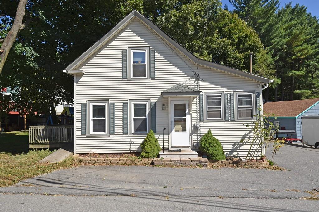 9 Catacunemaug Road Shirley, MA 01464 - Photo 1 of 22 a front view of a house with a yard garage and outdoor seating