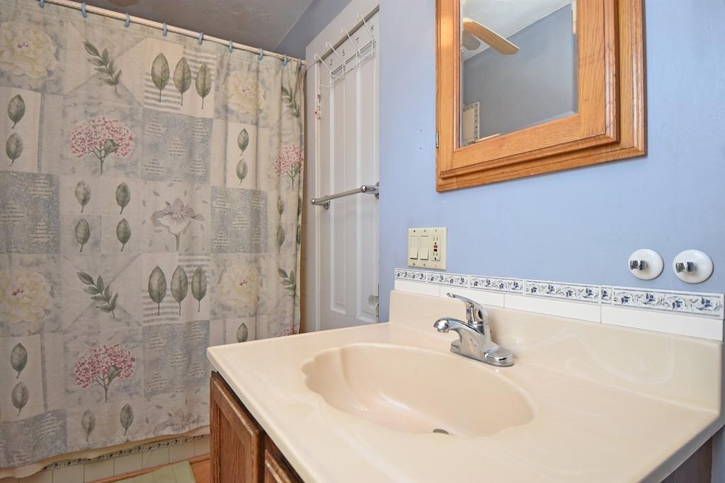 9 Catacunemaug Road Shirley, MA 01464 - Photo 11 of 22 a bathroom with a sink a mirror and a shower
