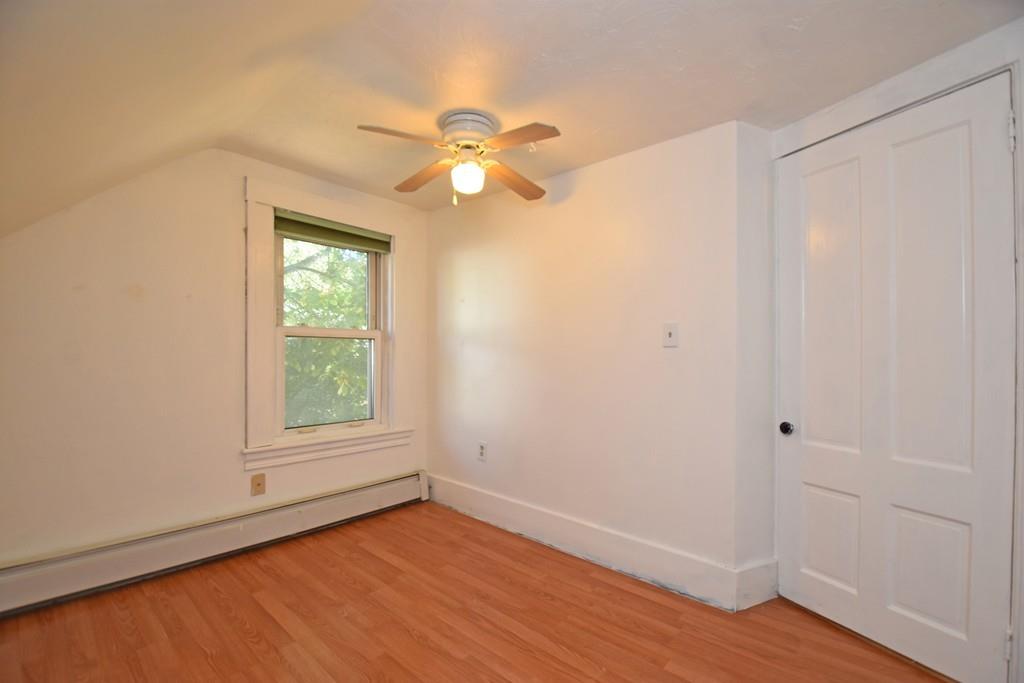 9 Catacunemaug Road Shirley, MA 01464 - Photo 14 of 22 an empty room with wooden floor fan and windows