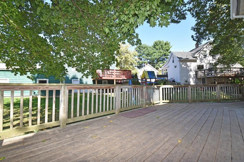 9 Catacunemaug Road Shirley, MA 01464 - Photo 18 of 22 a view of a deck with a large trees and wooden fence