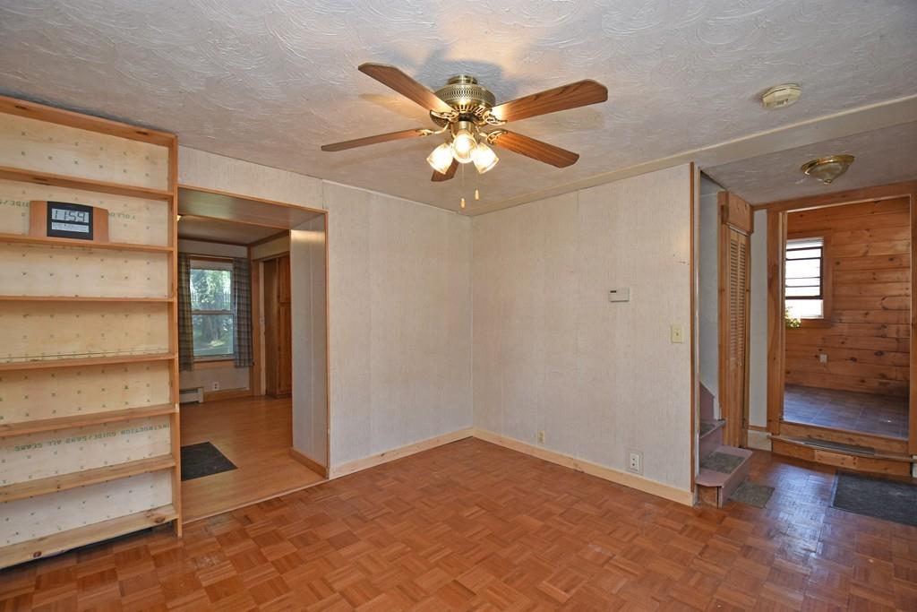9 Catacunemaug Road Shirley, MA 01464 - Photo 8 of 22 a view of an empty room with window and wooden floor