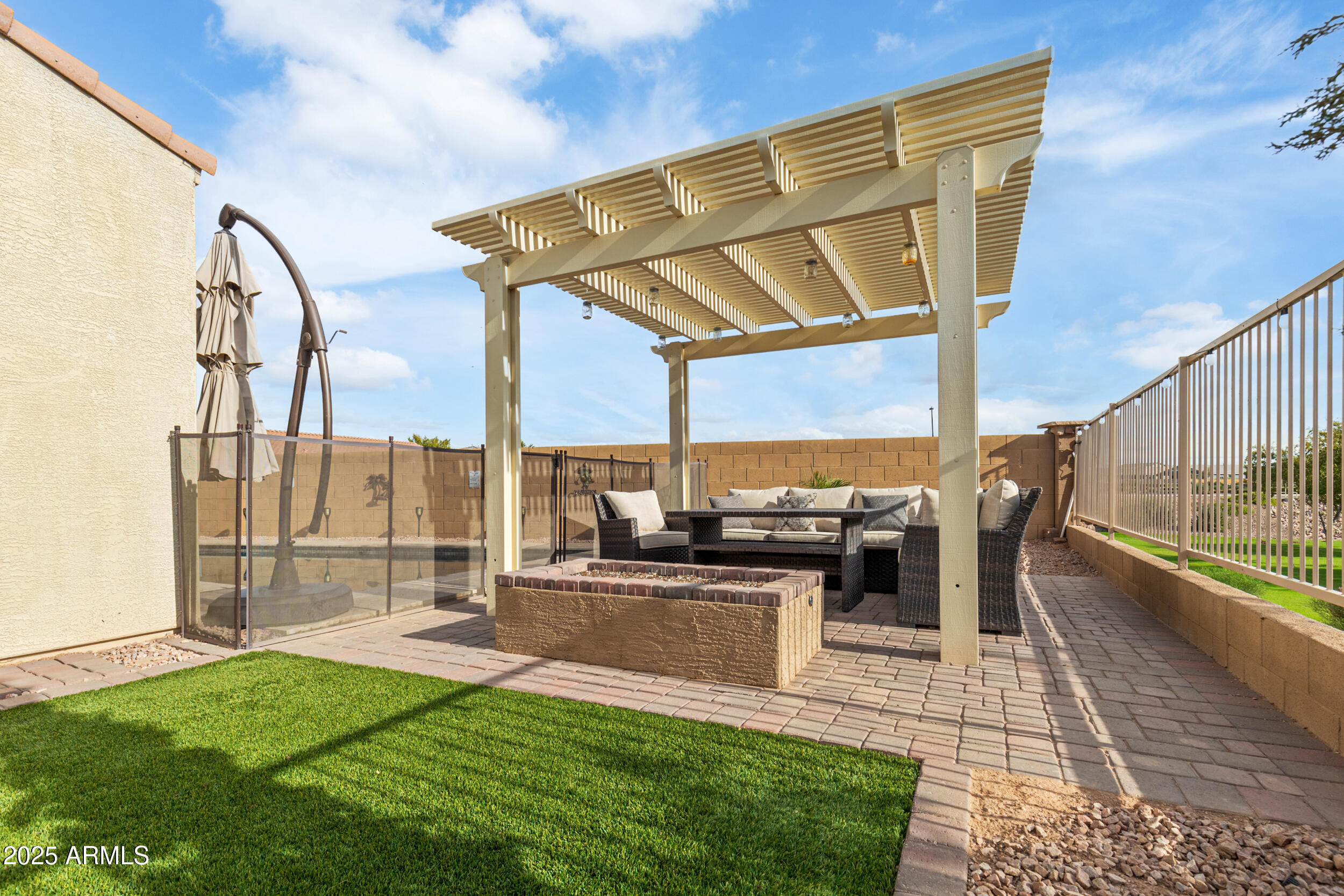 37104 Big Bend Road San Tan Valley, AZ 85140 - Photo 19 of 25 a view of a patio with a table chairs and a patio