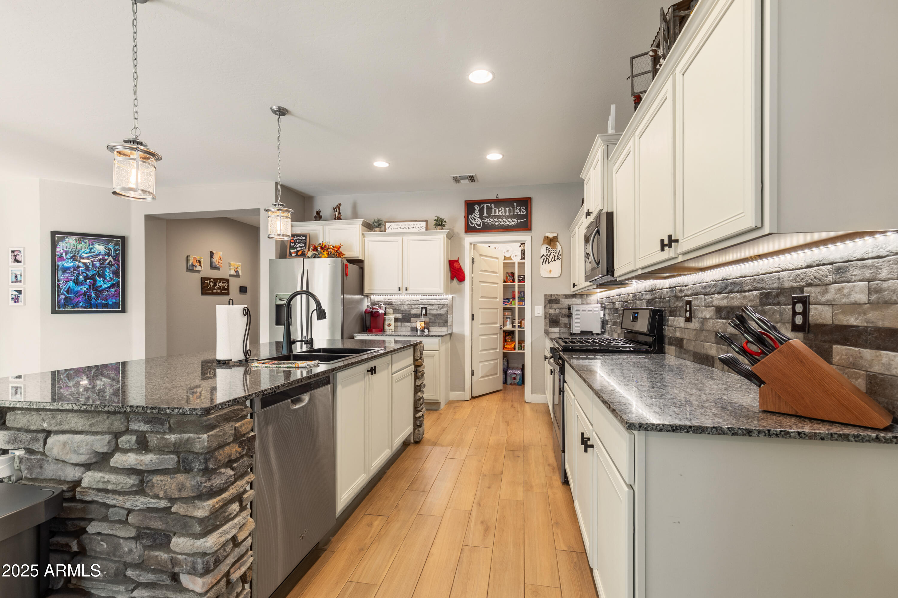 37104 Big Bend Road San Tan Valley, AZ 85140 - Photo 8 of 25 a kitchen with kitchen island granite countertop lots of counter top space and stainless steel appliances
