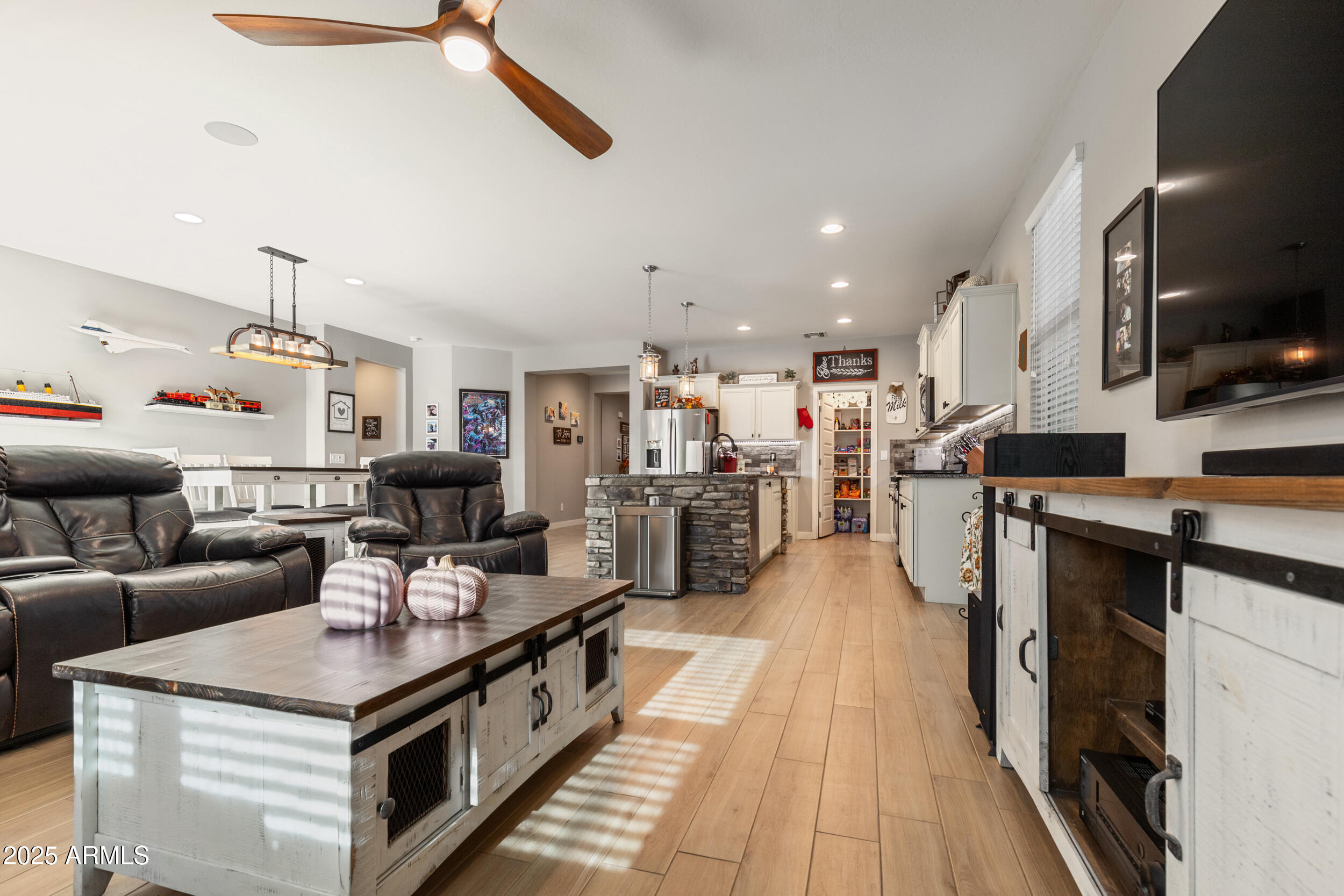 37104 Big Bend Road San Tan Valley, AZ 85140 - Photo 24 of 25 a kitchen with stainless steel appliances kitchen island granite countertop lots of counter top space