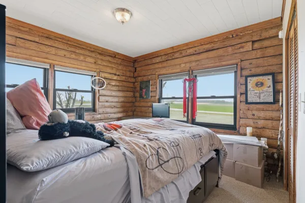 a bedroom with a bed a mirror and a shower