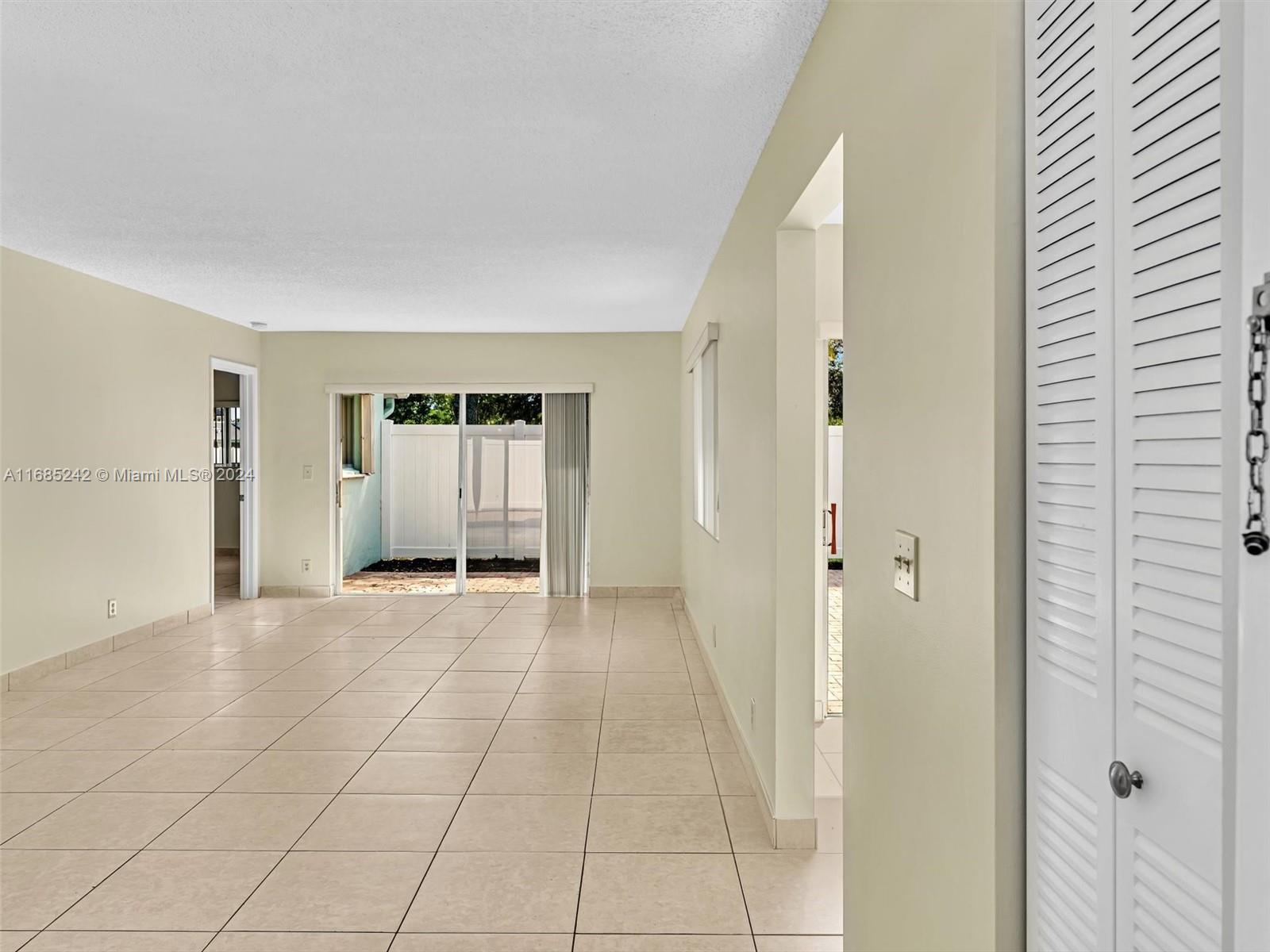 9185 Southwest 5th Street, Unit B Boca Raton, FL 33428 - Photo 13 of 38 a view of an empty room with cabinet and a window