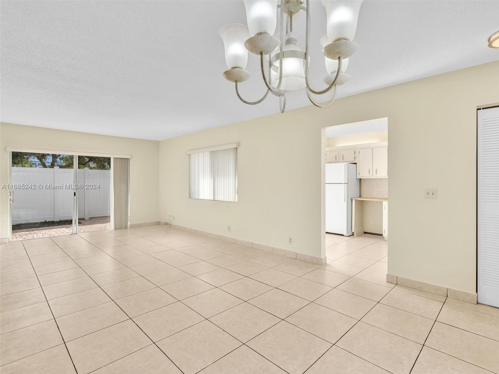 9185 Southwest 5th Street, Unit B Boca Raton, FL 33428 - Photo 18 of 38 a view of empty room with wooden floor and window
