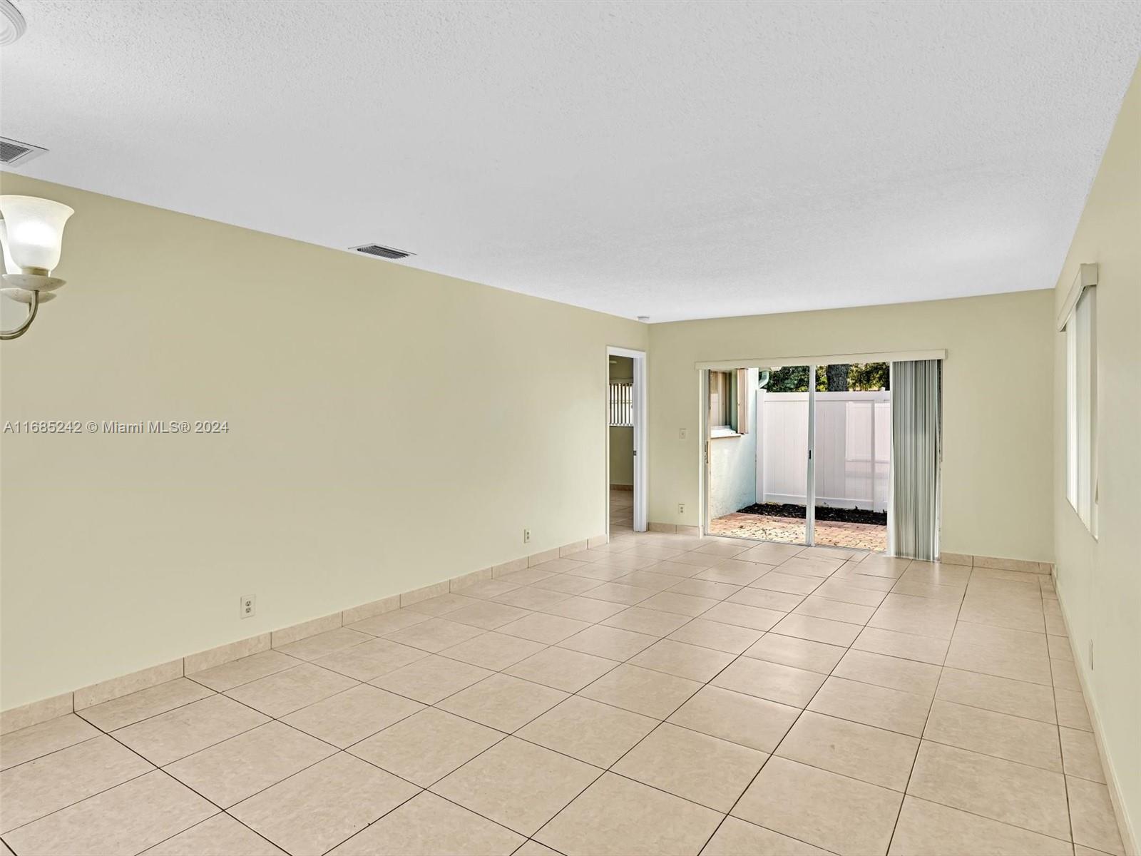 9185 Southwest 5th Street, Unit B Boca Raton, FL 33428 - Photo 20 of 38 a view of an empty room with a window