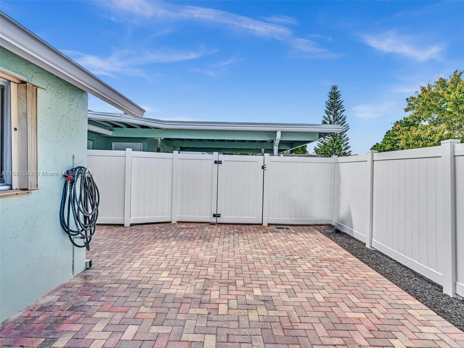 9185 Southwest 5th Street, Unit B Boca Raton, FL 33428 - Photo 26 of 38 a view of a porch with a table and chairs