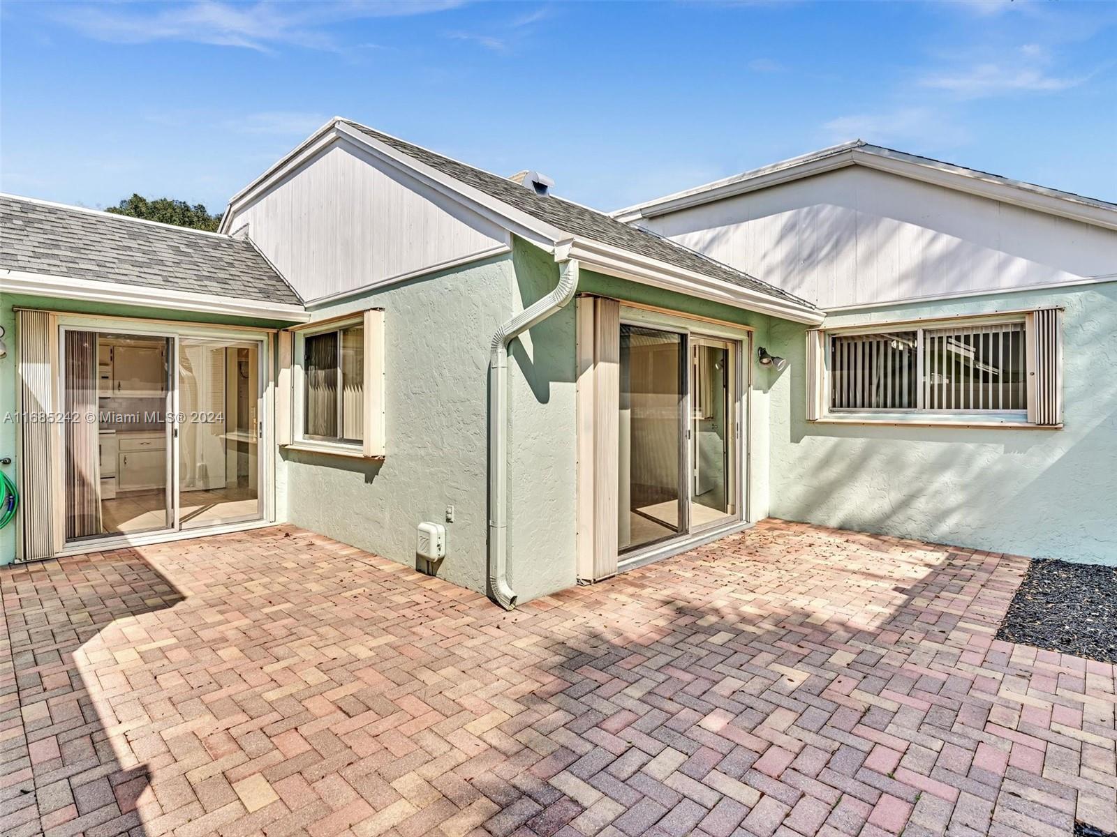 9185 Southwest 5th Street, Unit B Boca Raton, FL 33428 - Photo 29 of 38 a front view of a house with a yard