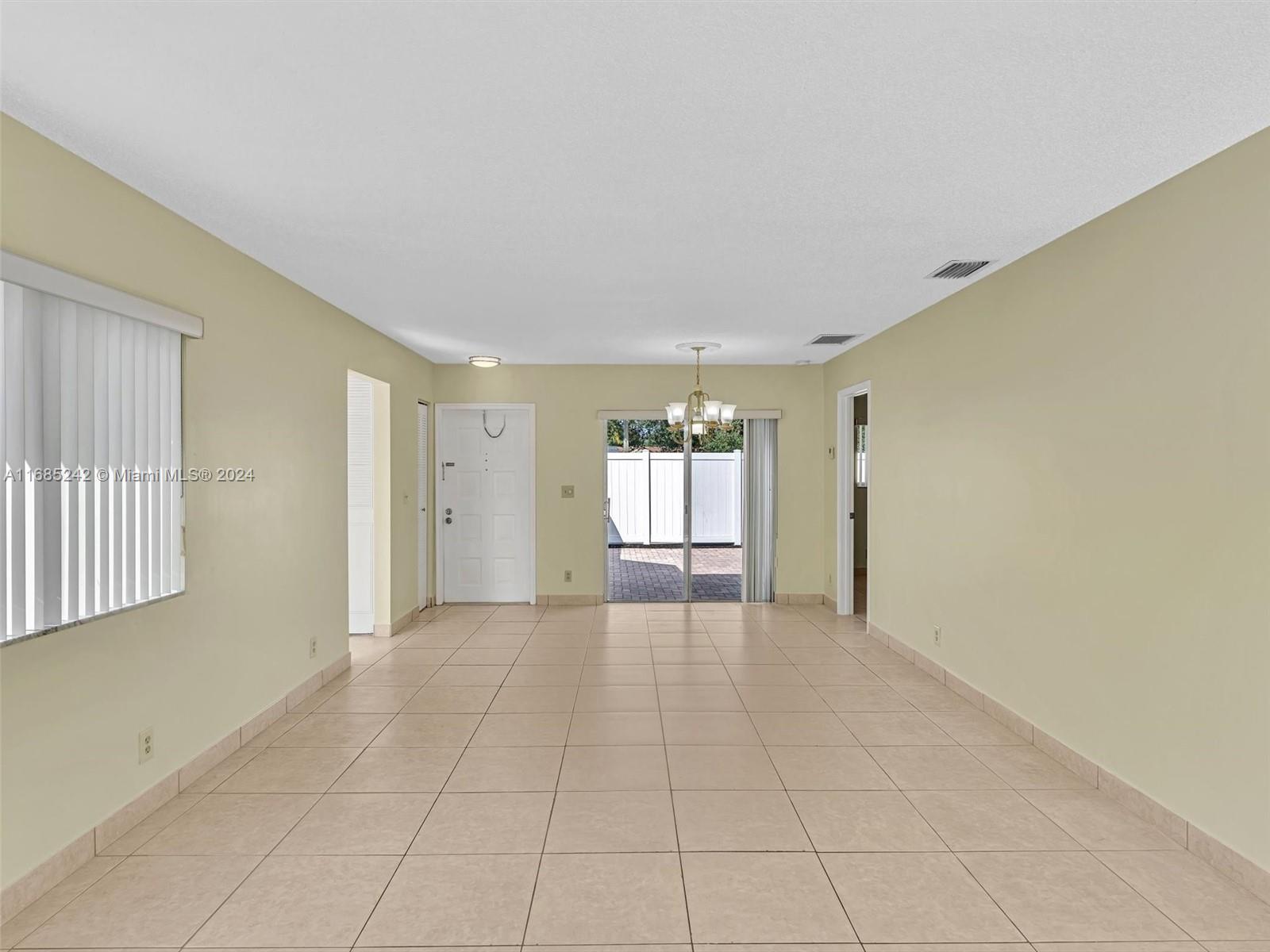 9185 Southwest 5th Street, Unit B Boca Raton, FL 33428 - Photo 31 of 38 a view of an empty room with a window