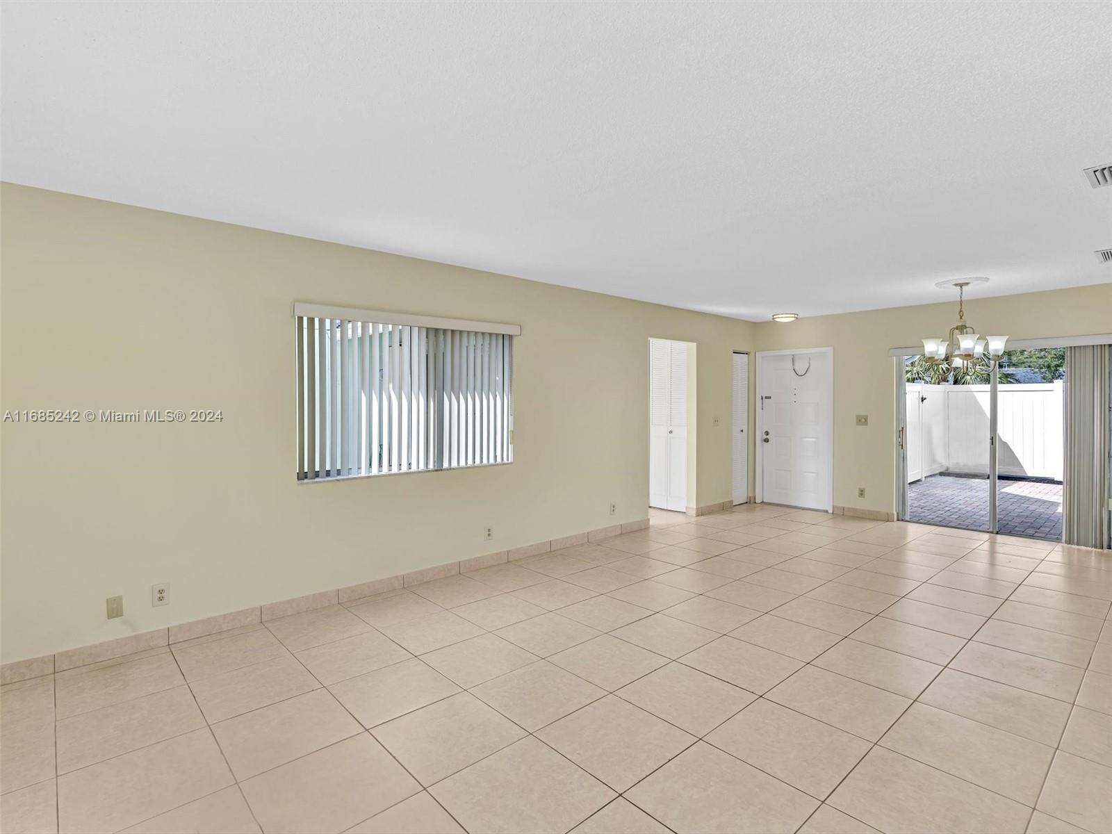 9185 Southwest 5th Street, Unit B Boca Raton, FL 33428 - Photo 32 of 38 a view of an empty room with a window