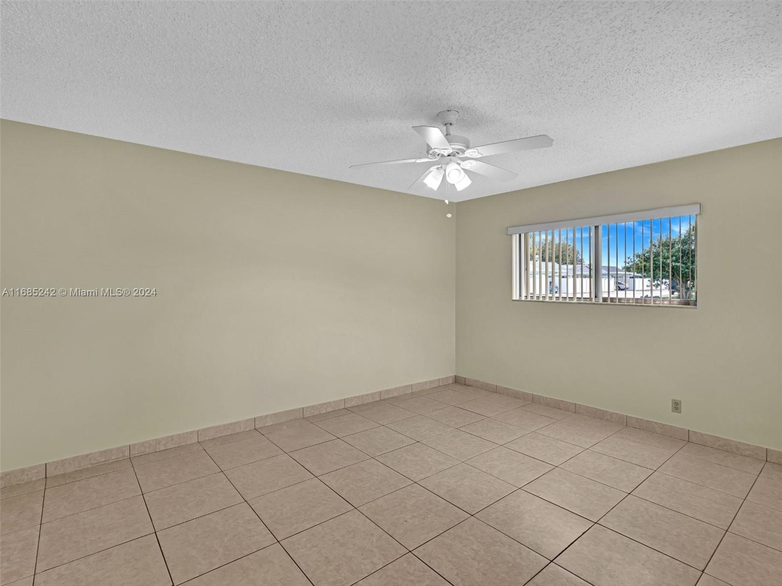 9185 Southwest 5th Street, Unit B Boca Raton, FL 33428 - Photo 34 of 38 a view of an empty room with a window