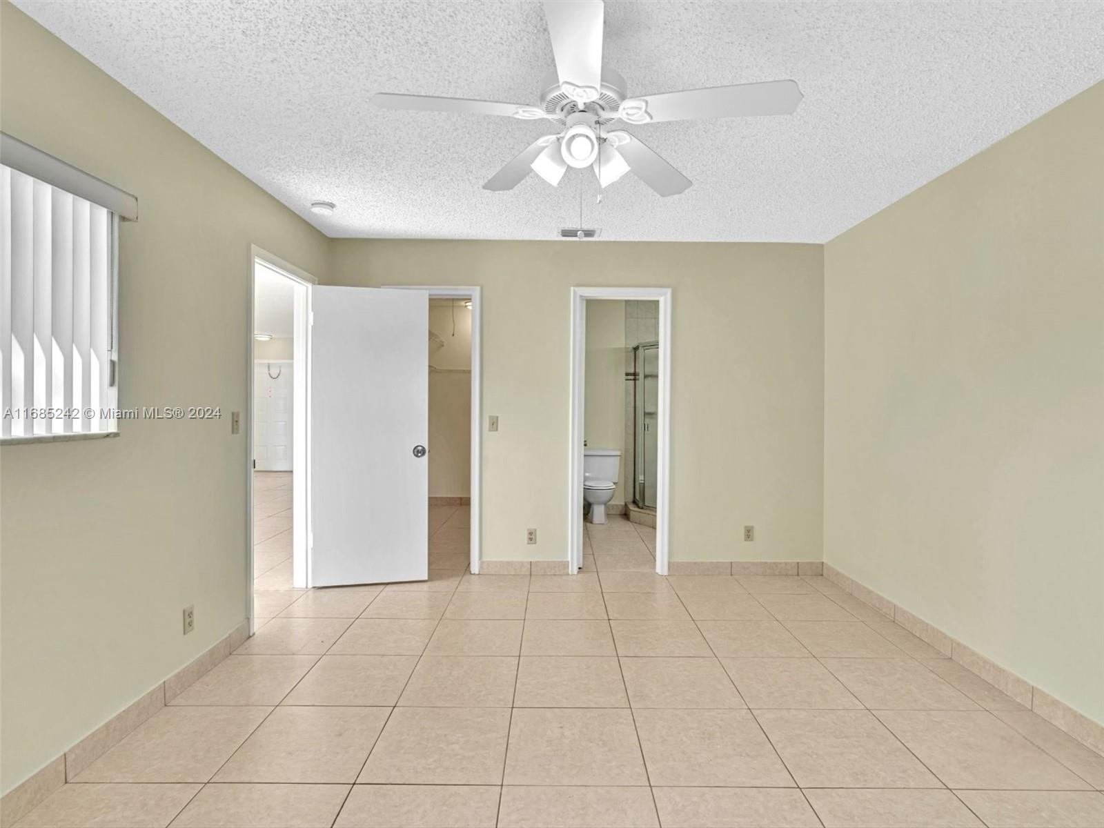 9185 Southwest 5th Street, Unit B Boca Raton, FL 33428 - Photo 36 of 38 a view of an empty room with a window