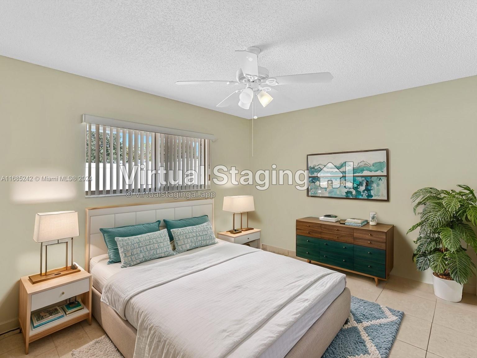 9185 Southwest 5th Street, Unit B Boca Raton, FL 33428 - Photo 4 of 38 a bedroom with a bed and a chandelier