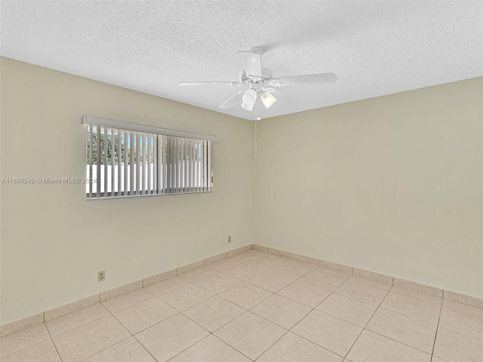 9185 Southwest 5th Street, Unit B Boca Raton, FL 33428 - Photo 5 of 38 an empty room with windows
