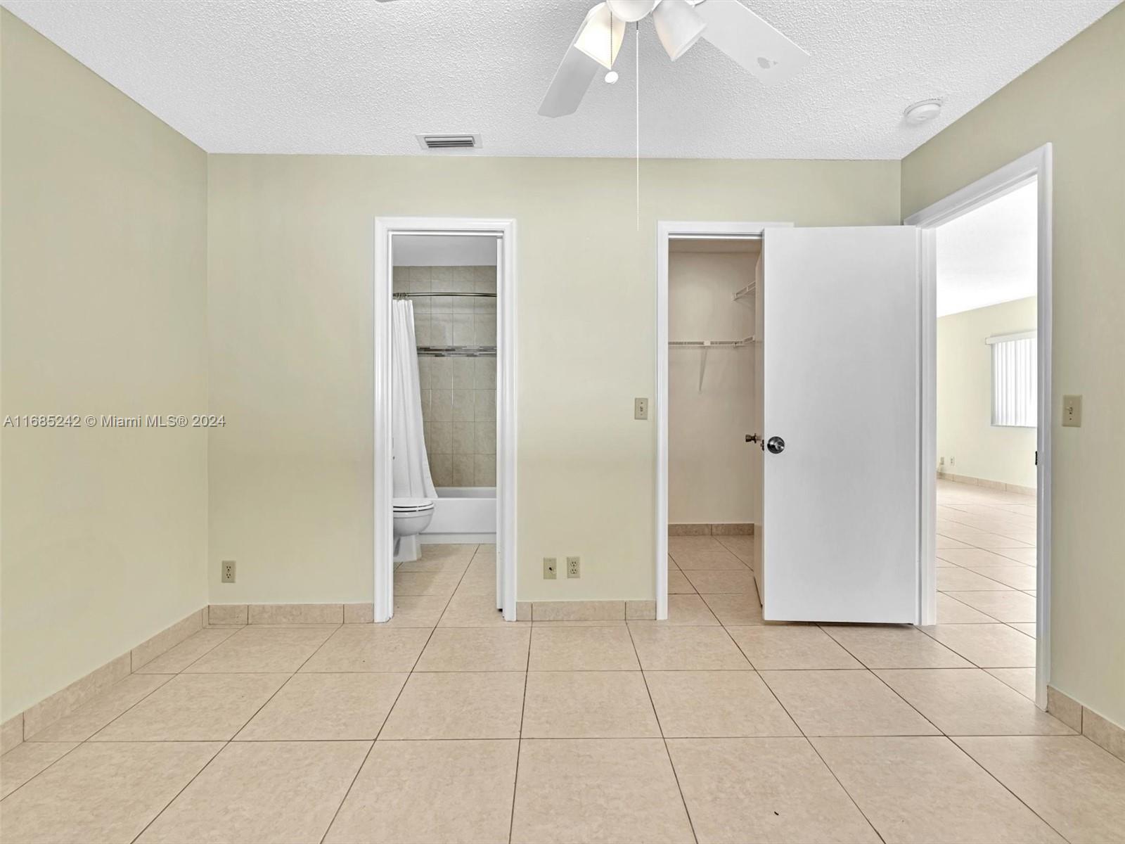 9185 Southwest 5th Street, Unit B Boca Raton, FL 33428 - Photo 6 of 38 a view of an empty room with a bathroom