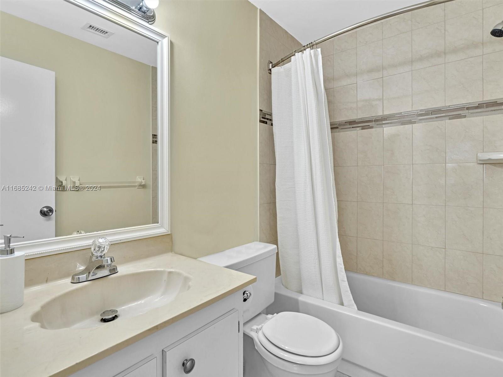 9185 Southwest 5th Street, Unit B Boca Raton, FL 33428 - Photo 8 of 38 a bathroom with a sink toilet and shower