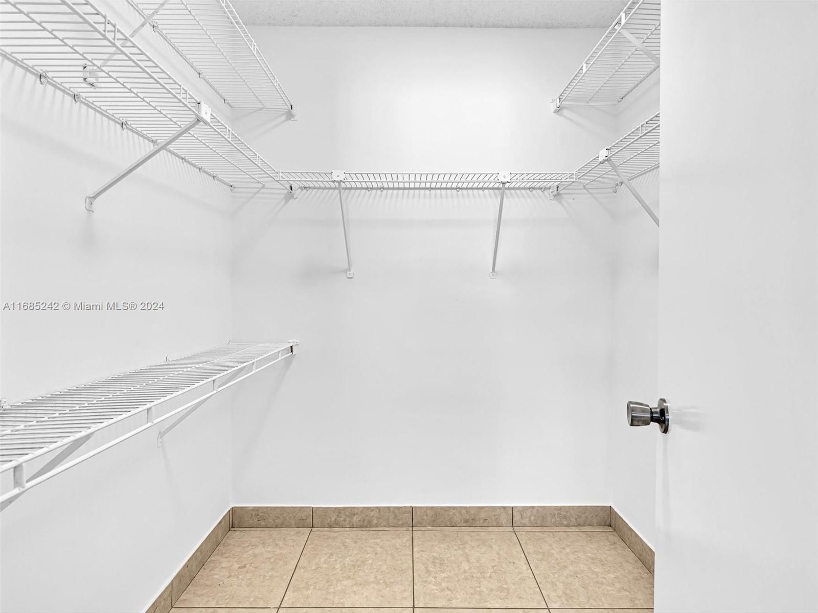 9185 Southwest 5th Street, Unit B Boca Raton, FL 33428 - Photo 9 of 38 a view of a room with racks on the wall