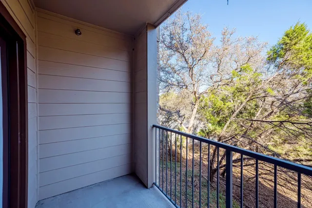 a view of a balcony with a tree