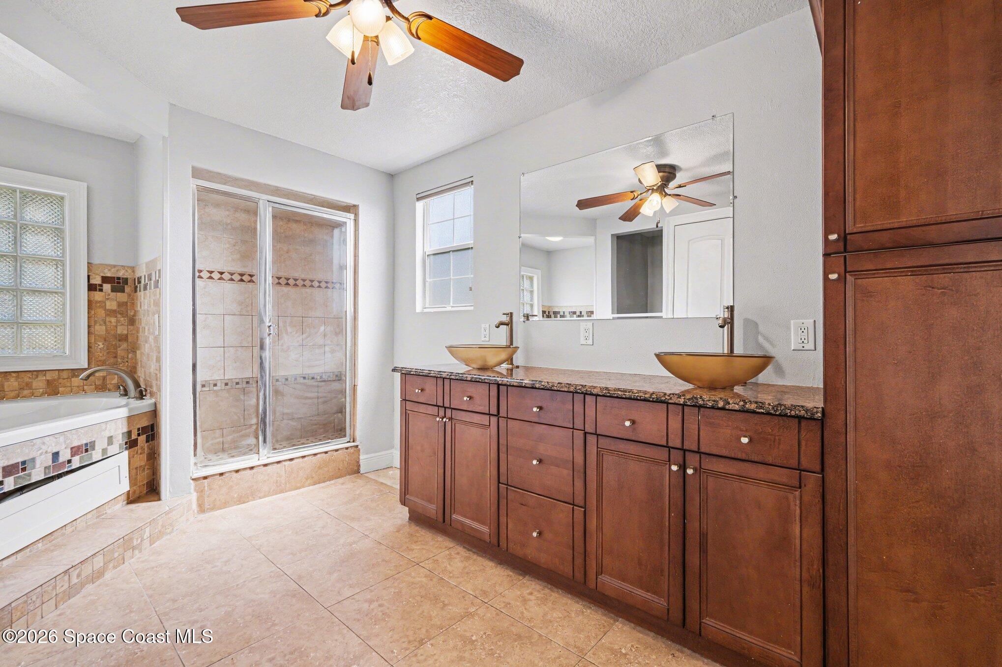 4950 Blounts Ridge Road Mims, FL 32754 - Photo 9 of 40 a spacious bathroom with a granite countertop sink a mirror and a shower