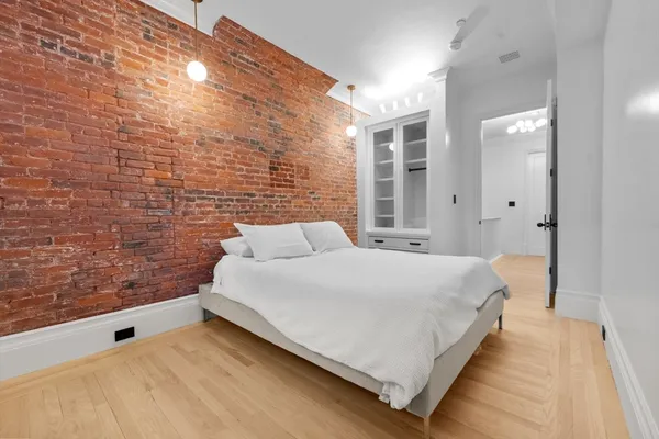 a bedroom with a bed and a wall painting