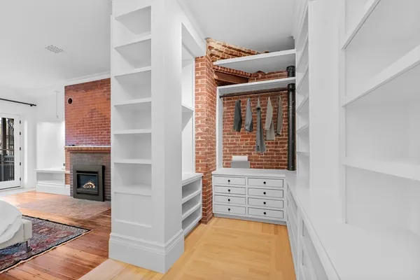 a view of an empty room with furniture and a fireplace