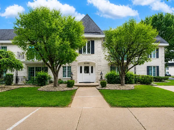 a front view of house with yard and green space