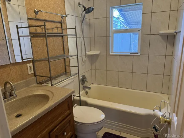 a bathroom with a sink a toilet and bathtub