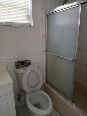 a white toilet sitting next to a window
