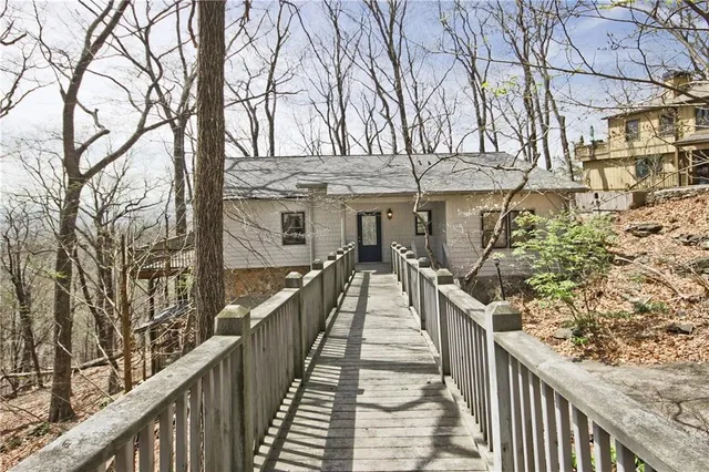a view of a house with large trees