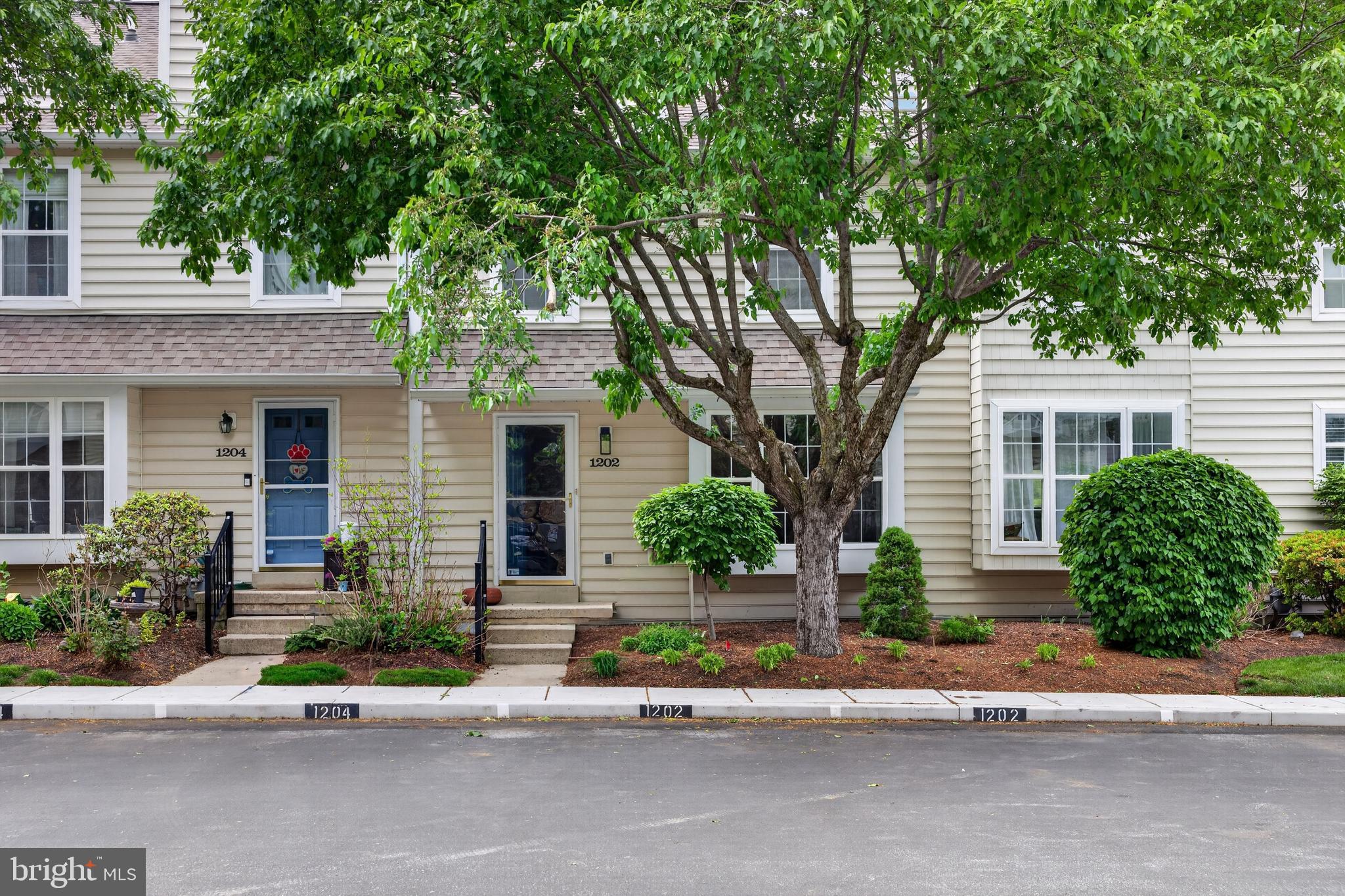1202 Harbour Ridge Lane Downingtown, PA 19335 - Photo 1 of 37 front view of a house with a bench and potted plants
