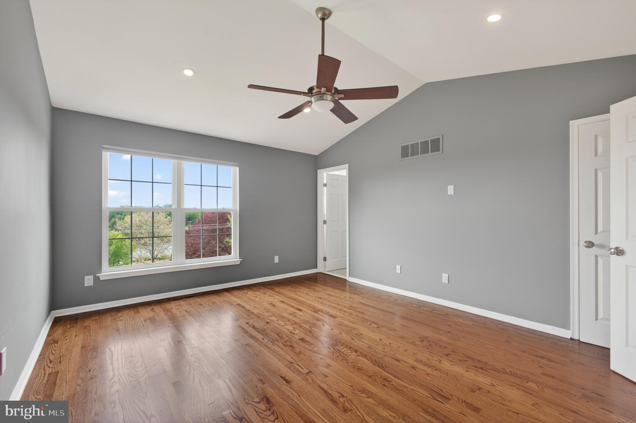 1202 Harbour Ridge Lane Downingtown, PA 19335 - Photo 13 of 37 an empty room with wooden floor and windows