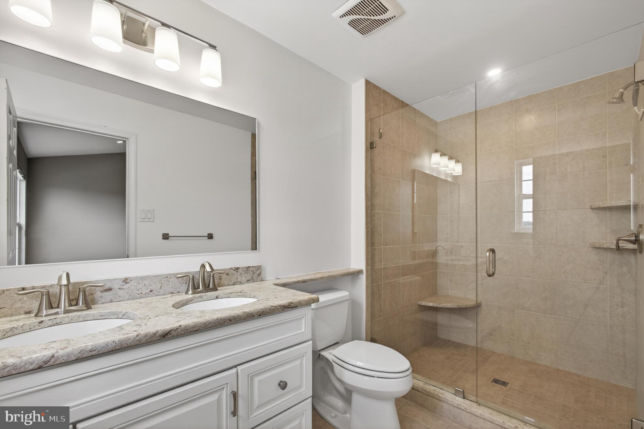1202 Harbour Ridge Lane Downingtown, PA 19335 - Photo 16 of 37 a bathroom with a granite countertop sink a toilet and shower