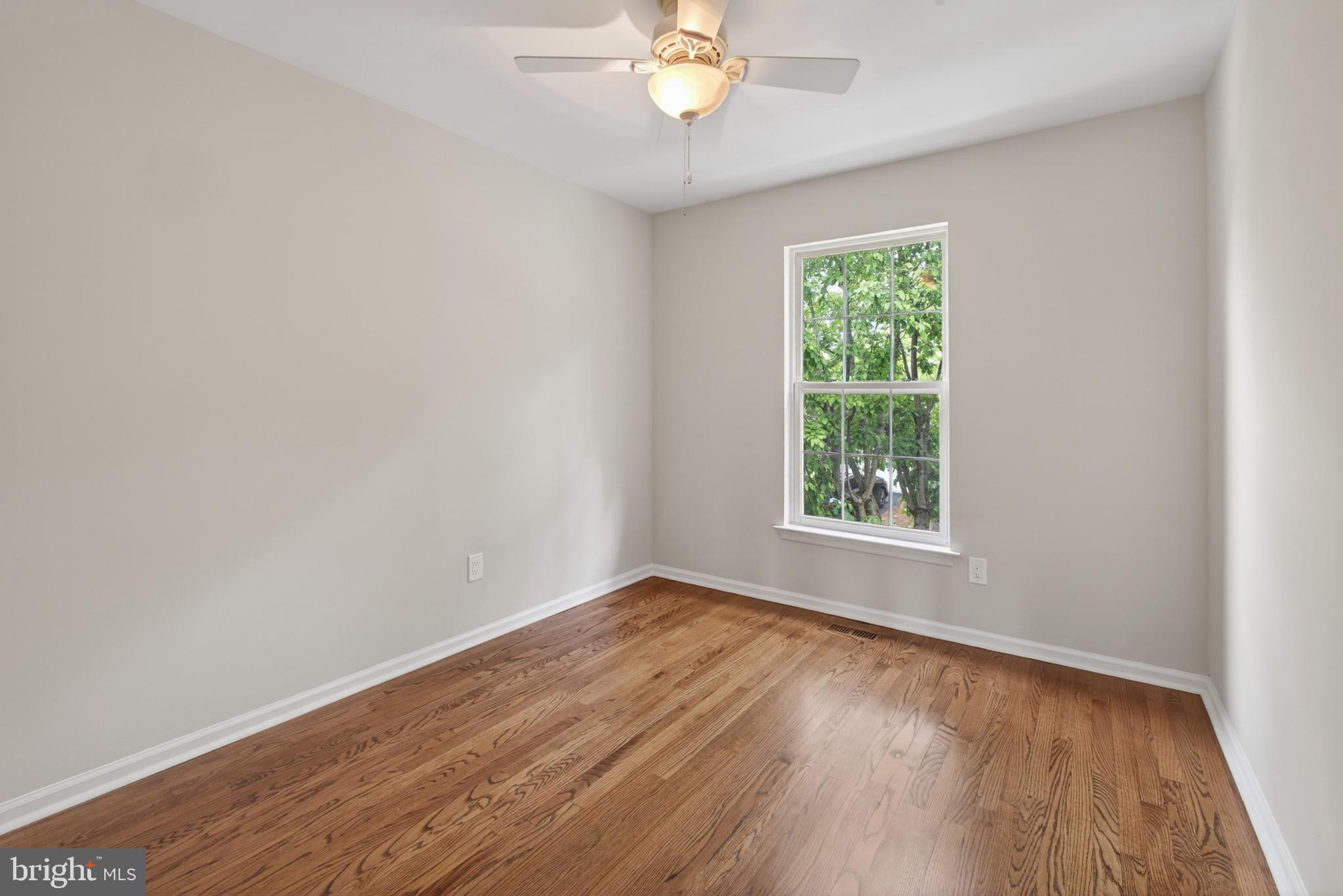 1202 Harbour Ridge Lane Downingtown, PA 19335 - Photo 21 of 37 a view of an empty room with wooden floor and a window