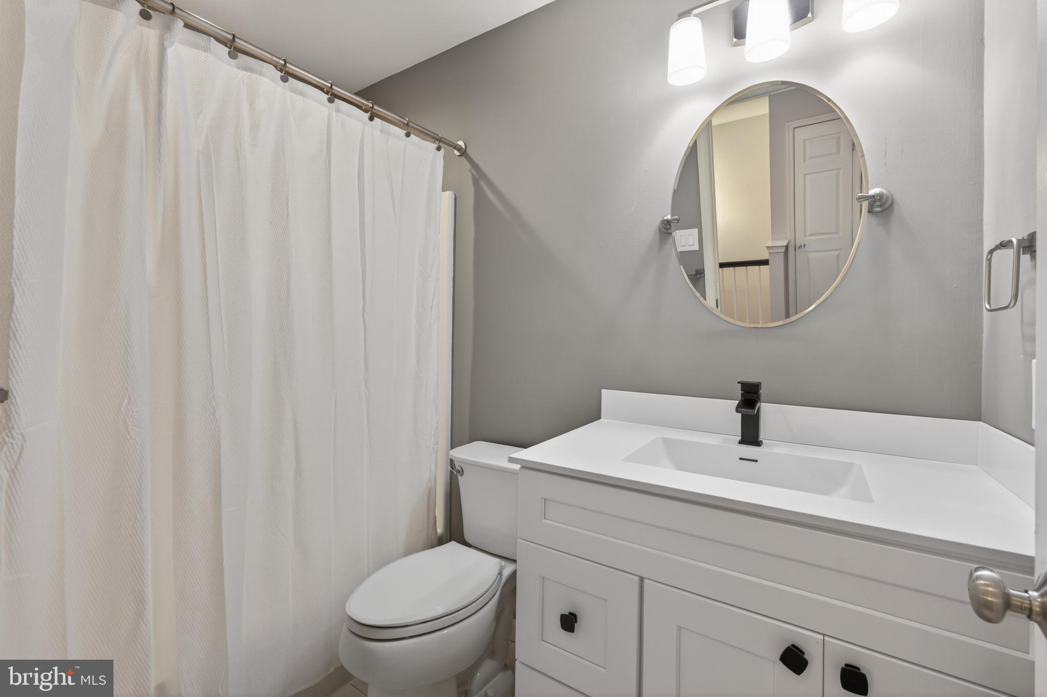 1202 Harbour Ridge Lane Downingtown, PA 19335 - Photo 23 of 37 a bathroom with a toilet a sink and a mirror