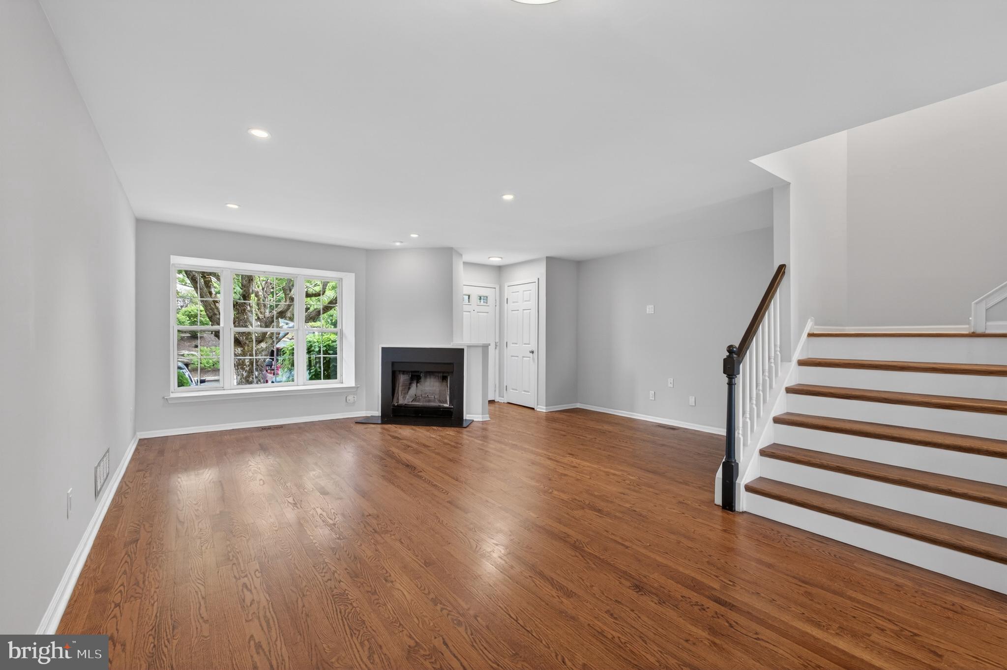 1202 Harbour Ridge Lane Downingtown, PA 19335 - Photo 3 of 37 a view of empty room with fireplace and wooden floor
