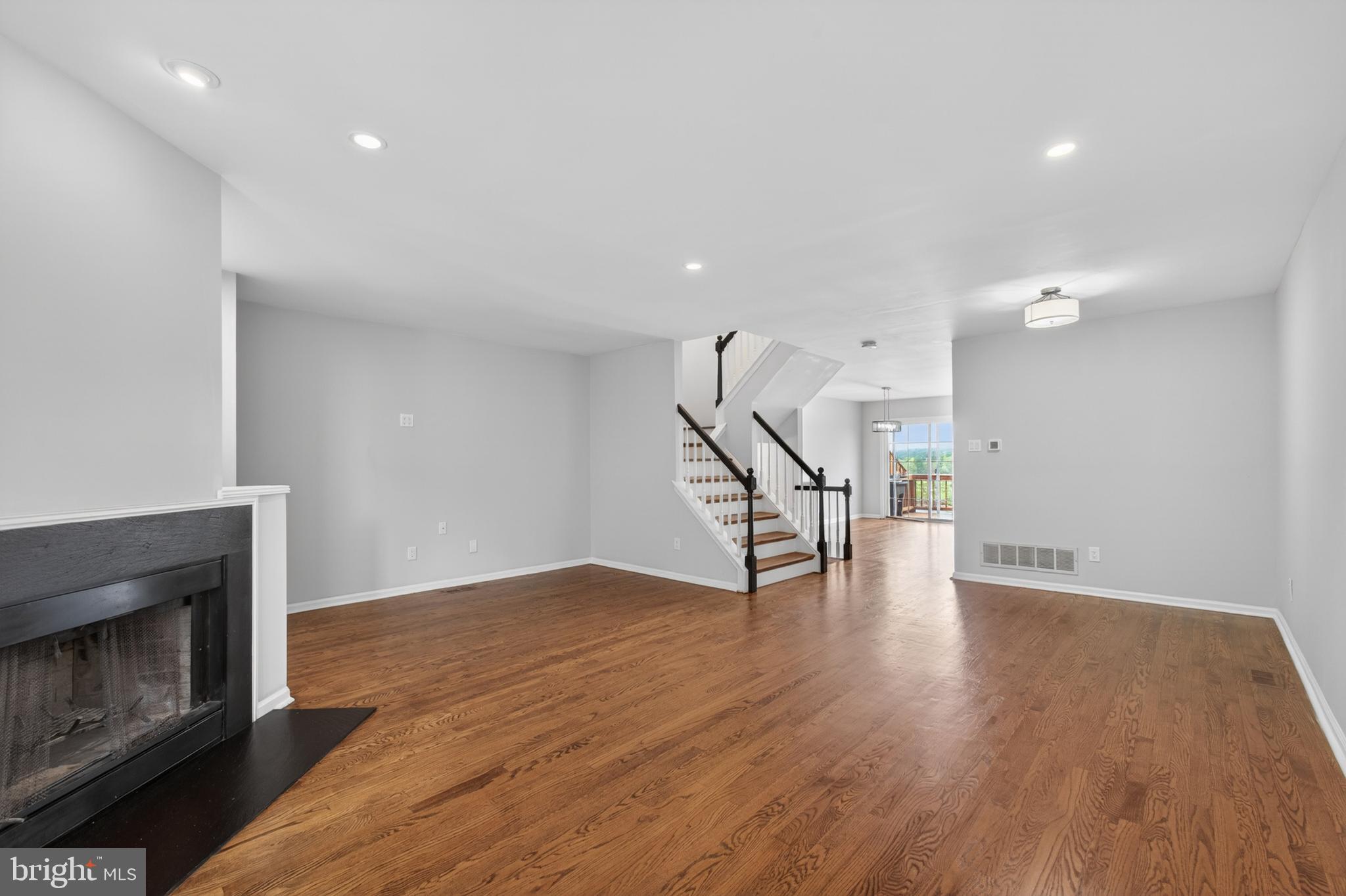 1202 Harbour Ridge Lane Downingtown, PA 19335 - Photo 4 of 37 a view of empty room with wooden floor and fireplace