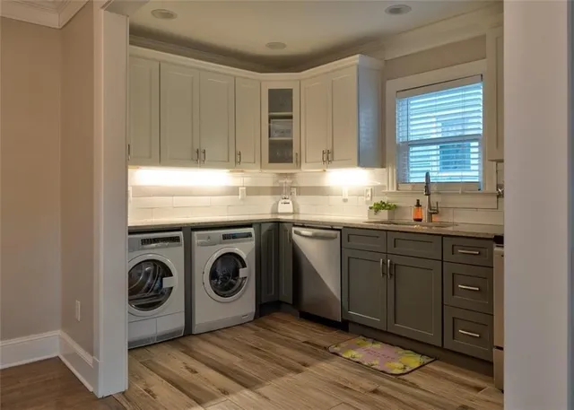 a kitchen with stainless steel appliances granite countertop a sink and cabinets