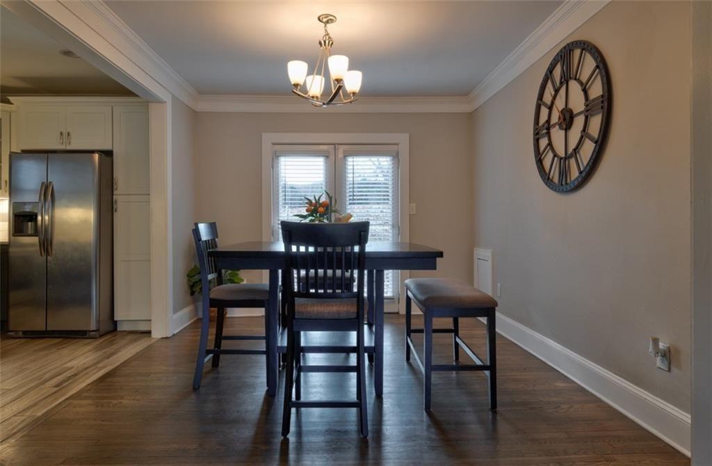 1074 Jefferson Avenue East Point, GA 30344 - Photo 3 of 13 a view of a dining room with furniture a chandelier and wooden floor